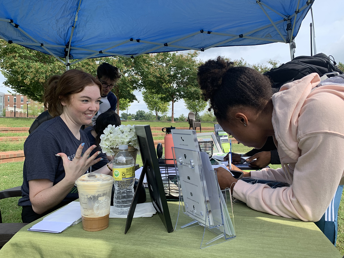 MTSU alumna and Green House Ministries staff member Abby Vaughn, left, shares information about their nonprofit organization with Anaiya Midget, 19, a junior business entrepreneur major from St. Petersburg, Fla. Dozens of students met with 16 on- and off-campus organizations recently to learn about volunteer opportunities for the coming academic year. (MTSU photo by Randy Weiler)