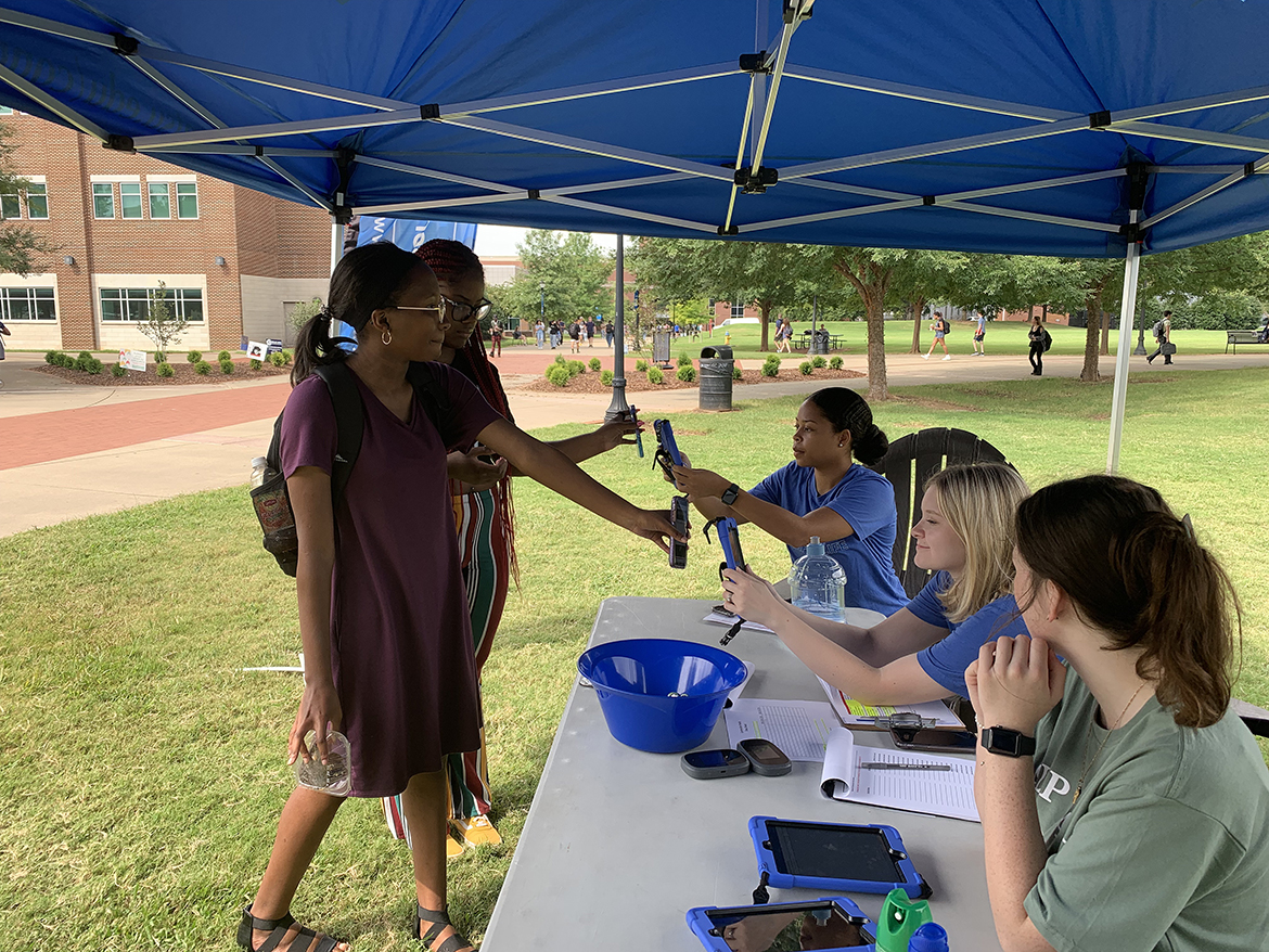 MTSU alumna and Green House Ministries staff member Abby Vaughn, left, shares information about their nonprofit organization with Anaiya Midget, 19, a junior business entrepreneur major from St. Petersburg, Fla. Dozens of students met with 16 on- and off-campus organizations recently to learn about volunteer opportunities for the coming academic year. (MTSU photo by Randy Weiler)