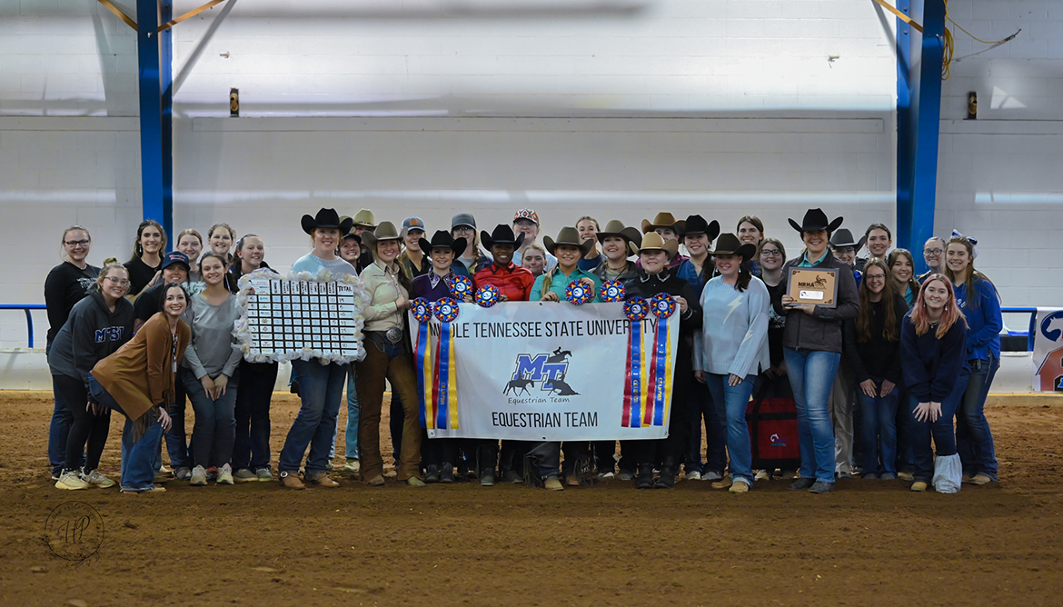 Middle Tennessee State University equestrian team members join the coaches and winning riders from the Intercollegiate Horse Shows Association Western Semi-Finals March 22-23 at the Tennessee Livestock Center in Murfreesboro, Tenn. MTSU earned the team championship, qualifying for the IHSA Nationals in May. MTSU is the defending national champion. Holding the trophy is Christy Landwehr with semi-finals title sponsor National Reining Horse Association. (Submitted photo by Hanna Price Photography)