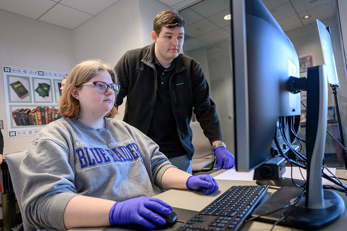 Middle Tennessee State University forensic science major Brittney Cupp, left, and chemistry graduate student Ethan Coyle review incoming data from the X-ray fluorescence spectroscopy, or XRF, to identify and quantify toxic compounds and heavy metals found within the pigments used in many of the 19th-century books that are housed in the university’s Special Collections at James E. Walker Library in Murfreesboro, Tenn. The “Poisoned Pages” project was made possible through a University Research and Creative Activity, or URECA, grant that bolstered the collaboration between the Department of Chemistry and the library. (MTSU photo by J. Intintoli)