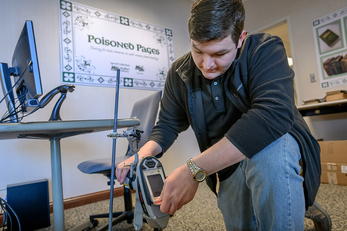 Middle Tennessee State University chemistry graduate student Ethan Coyle sets up the X-ray fluorescence spectroscopy, or XRF, to identify and quantify toxic compounds and heavy metals found within the pigments used in many of the 19th-century books that are housed in the university’s Special Collections at James E. Walker Library in Murfreesboro, Tenn. The “Poisoned Pages” project was made possible through a University Research and Creative Activity, or URECA, grant that bolstered the collaboration between the Department of Chemistry and the library. (MTSU photo by J. Intintoli)