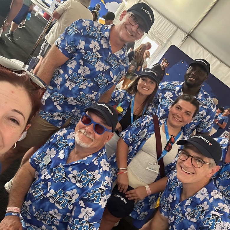 Wearing university-branded shirts and donning Southwest caps, part of the delegation representing the Aerospace Department of Middle Tennessee State University in Murfreesboro, Tenn., take a selfie with a representative of Southwest Airlines at the 72nd EAA AirVenture aviation showcase held July 21-27 in Oshkosh, Wisc. Led by Greg Van Patten, dean of the College of Basic and Applied Sciences, the MTSU group visited Southwest’s exhibition area as part of a Destination 225 briefing. MTSU is a member of the carrier’s Destination 225 program, which provides participating students with fast tracks to jobs upon graduation. (MTSU photo by Andrew Oppmann)