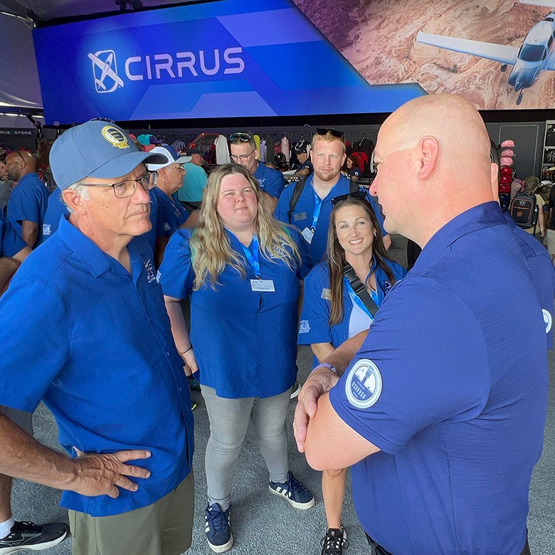 Mark Byrnes, second from left, provost of Middle Tennessee State University in Murfreesboro, Tenn., speaks with a representative from Cirrus Aircraft at the company’s exhibition area during the 72nd EAA AirVenture aviation showcase held July 21-27 in Oshkosh, Wisc. Looking on are other members of the MTSU delegation attending the event to network and represent the university’s highly touted Aerospace Department. (MTSU photo by Andrew Oppmann)