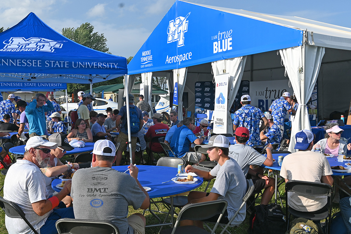 A host of Middle Tennessee State University Aerospace alumni attend a university-hosted barbecue on site at the 72nd EAA AirVenture aviation showcase held July 21-27 in Oshkosh, Wis. MTSU Aerospace returned to the event with a delegation of faculty, staff and students to showcase the aerospace program, reconnect with alums and network with industry leaders. (MTSU photo by Andrew Oppmann)