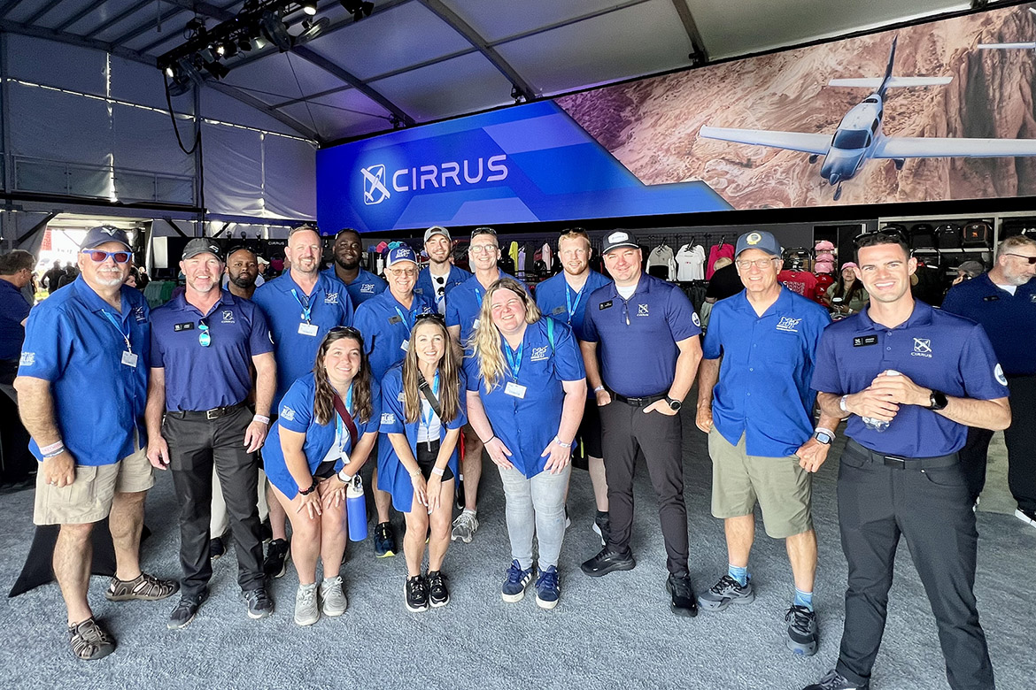 A group of representatives from Middle Tennessee State University’s Aerospace Department, led by Provost Mark Byrnes, second from right, stops by the Cirrus Aircraft exhibition tent set up at the 72nd EAA AirVenture aviation showcase held July 21-27 in Oshkosh, Wis. MTSU Aerospace returned to the event with a delegation of faculty, staff and students to showcase the aerospace program. (MTSU photo)