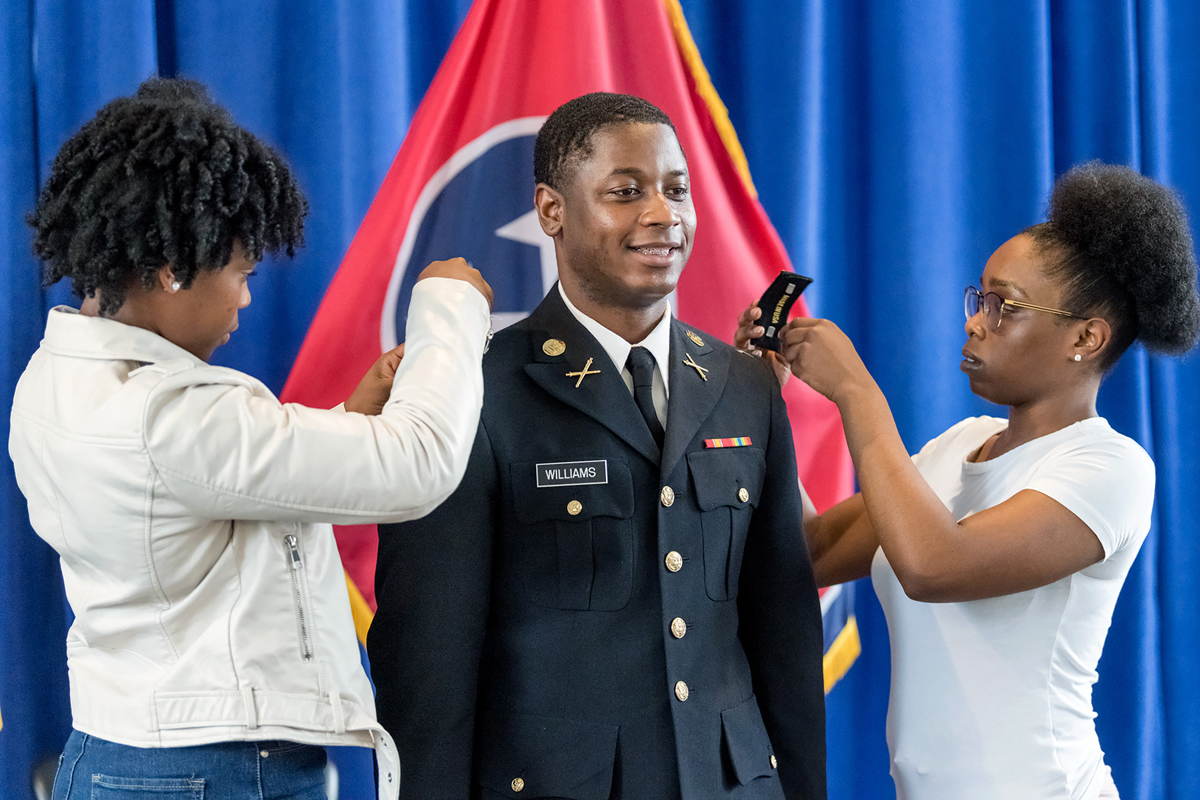 Best friends Terrah Black, left, and Melanie Halmon pin Master of Science in Professional Science biostatistics major Juante J. Williams of Memphis, Tenn., during the ROTC commissioning ceremony in the Tom H. Jackson Building’s Cantrell Hall Friday, May 8. (MTSU photo by J. Intintoli)