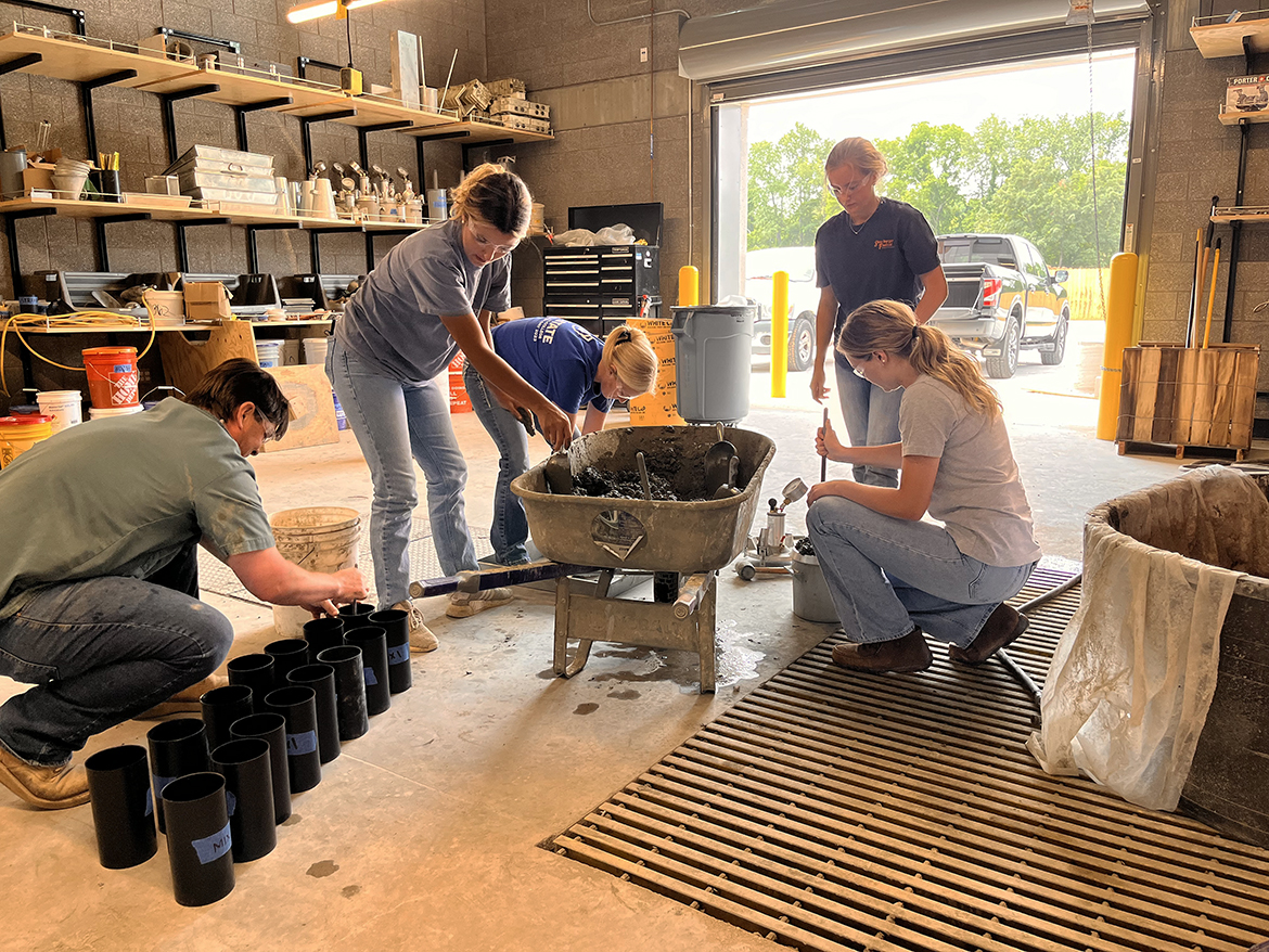 Working with Middle Tennessee State University Concrete Industry Management program clinical instructor Kevin Overall, left, CIM students Arie Milam, sisters Carlie and Claire Mullins and Ashlyne Roeger check concrete mixes in the laboratory in the School of Concrete and Construction Management Building earlier this summer. The four have fulfilled requirements as part of a NASA Minority University Research and Education Project grant. They will meet Big Machine Music City Grand Prix track designer for a second time Friday, Aug. 4. (Submitted photo)