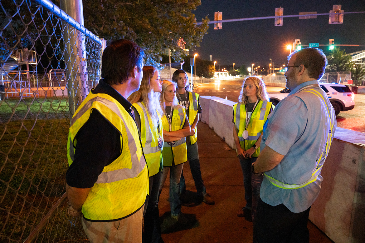 Middle Tennessee State University Concrete Industry Management Director Jon Huddleston, left, and students Ashlyne Roeger of Murfreesboro, Tenn., Carlie Mullins of Fayetteville, Tenn., Arie Milam of Clarksville, Tenn., and Claire Mullins of Fayetteville observe barrier set-up with MTSU alumnus Charlie Legeman, right, senior sales director for the Big Machine Music City Grand Prix, for the upcoming NTT IndyCar Series race weekend, set for Aug. 4-6 in downtown Nashville, Tenn. (MTSU photo by James Cessna)