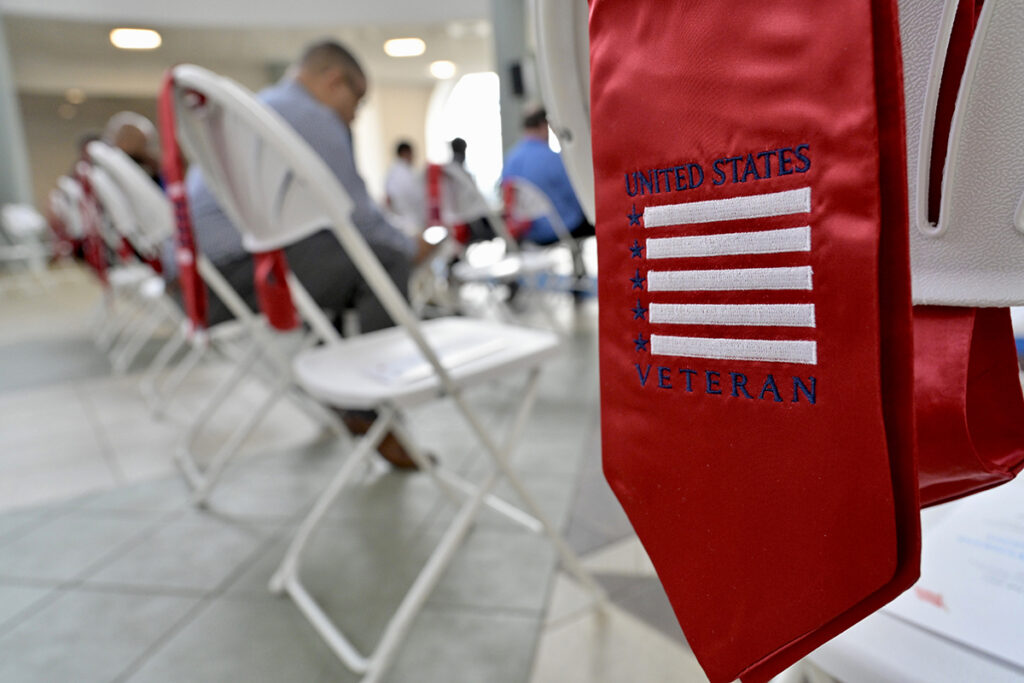A red stole rests on the back of a chair before the start of the MTSU Graduating Veterans Stole Ceremony Wednesday, Dec. 1, in the Miller Education Center second-floor atrium. Graduating veterans will wear their stoles at commencement Saturday, Dec. 11, in Murphy Center. MTSU’s Daniels Veterans Center hosts stole ceremonies before the veterans graduate from the university. (MTSU photo by Andy Heidt)