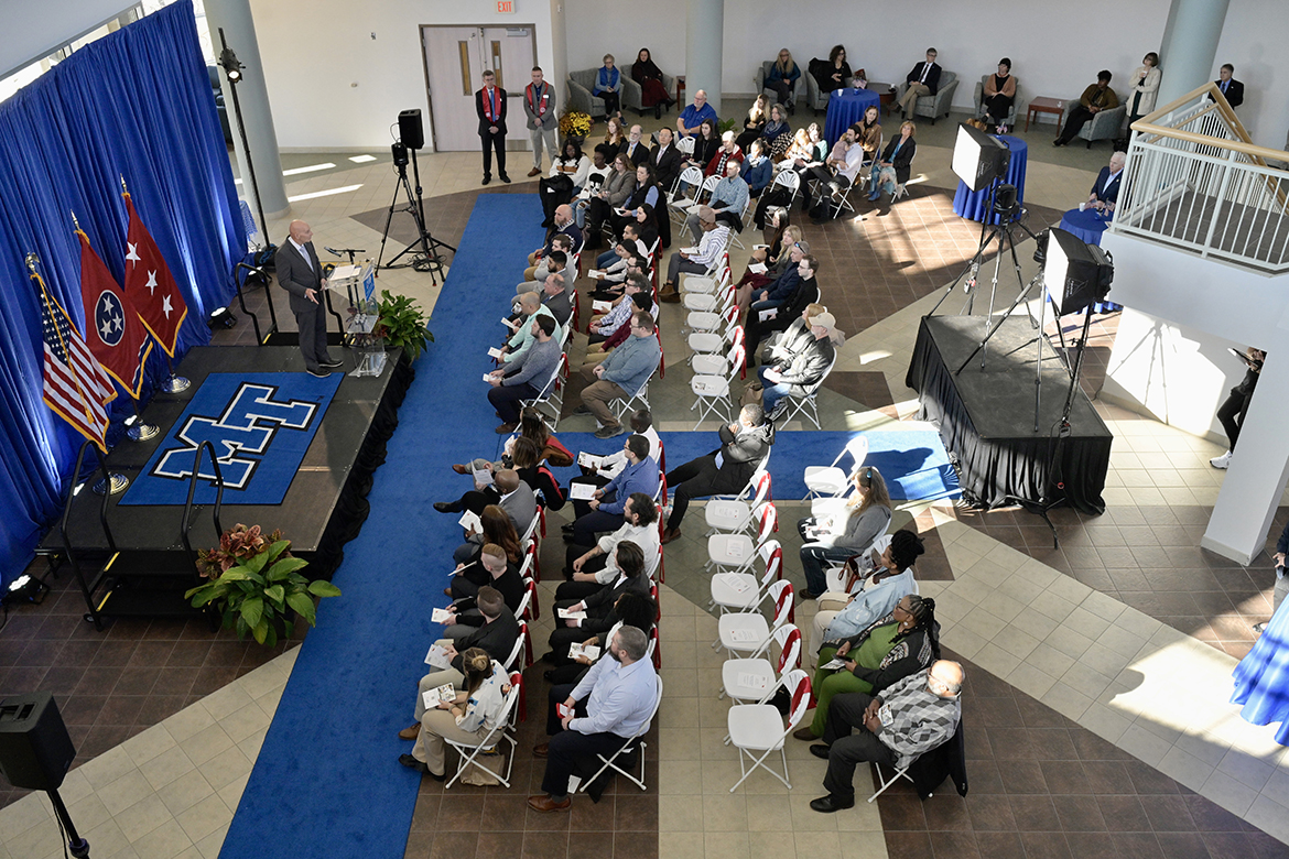 MTSU student veterans and other attendees listen as Middle Tennessee State University’s Keith M. Huber, senior adviser for veterans and leadership initiatives, congratulates them for both their service to their country and reaching the graduation stage in their pursuit to a degree and career in a specialized area Wednesday, Nov. 30, during the Graduating Veterans Stole Ceremony in the Miller Education Center’s second-floor atrium on Bell Street near campus. Of the 56 student veterans graduating Saturday, Dec. 10, in Murphy Center, 41 attended the ceremony, receiving red stoles to wear at graduation. (MTSU photo by Andy Heidt)