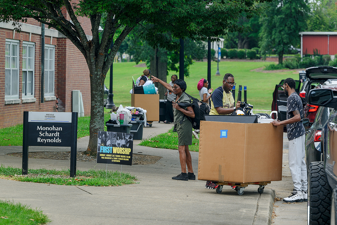A family helping their son move into Middle Tennessee State University student housing receives directions outside Monohan, Schardt and Reynolds halls on campus in Murfreesboro, Tenn., Wednesday, Aug. 20. Thousands of new and returning students will be moving in during the three-day window ending Friday, Aug. 22. (MTSU photo by Andy Heidt)