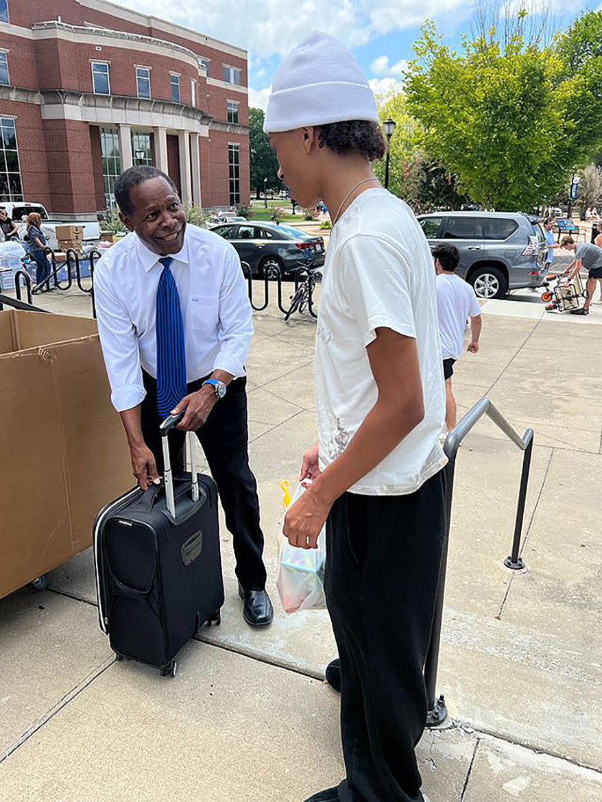 Middle Tennessee State University President Sidney A. McPhee, left, carries luggage for a freshman moving into campus Friday, Aug. 22, at Jim Cummings Hall on campus in Murfreesboro, Tenn. It marked the finale of three days of new and returning students moving into campus housing for the start of the fall semester, with classes starting Monday, Aug. 25. (MTSU photo by Andrew Oppmann)