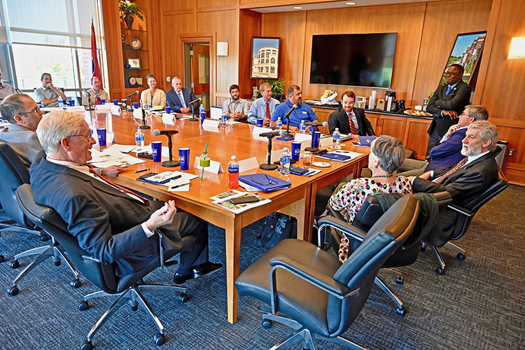 MTSU President Sidney A. McPhee, standing far right, listens as alumnus Paul Martin Jr., seated left, who is now involved with the Tennessee ginseng export trade, makes a point during the Symposium on the Science, Traditions and Economics of Tennessee Ginseng in the Student Union President’s Conference Room. (MTSU photo by Andrew Oppmann)