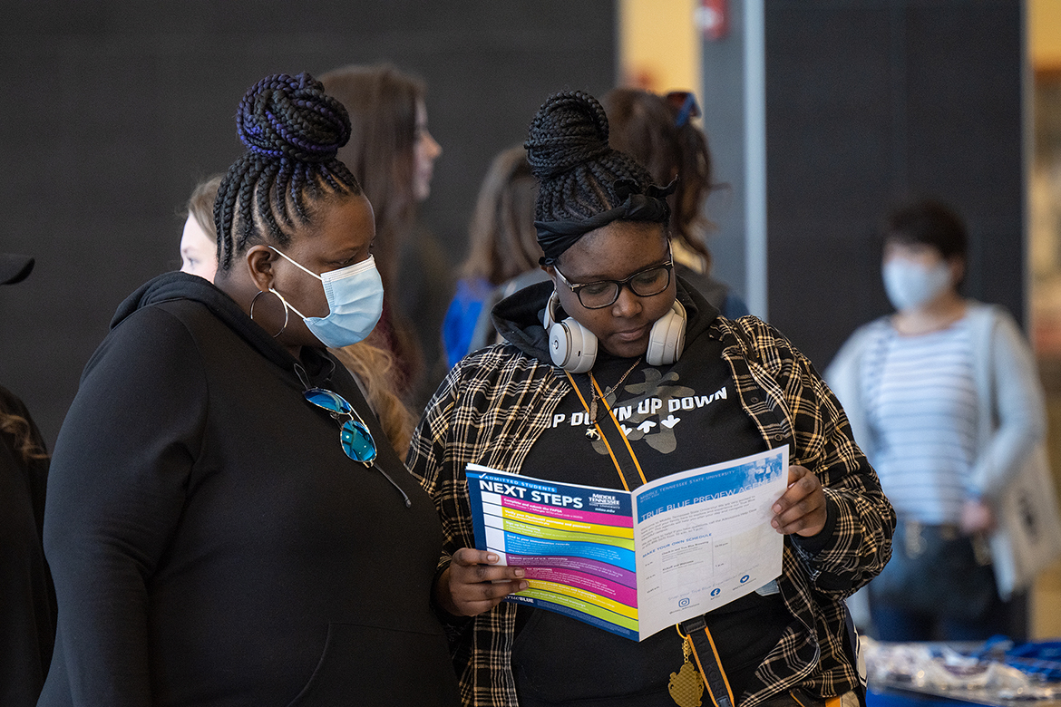 A mother and daughter visiting during the MTSU True Blue Preview in March check out the agenda for the day’s event. Hundreds of prospective students will be attending Saturday preview events scheduled on Oct. 1 and Nov. 5. (MTSU file photo by Cat Curtis Murphy)