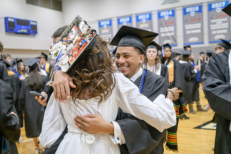 Two proud Middle Tennessee State University graduates share a congratulatory hug as they prepare to receive their degrees at the spring 2025 commencement ceremony held Friday, May 9, inside Murphy Center on the MTSU campus in Murfreesboro, Tenn. (MTSU photo by J. Intintoli)