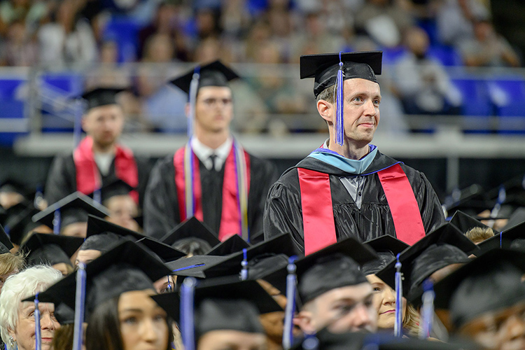 Middle Tennessee State University graduating student veterans, wearing their special red stoles, are acknowledged prior to receiving their degrees at the spring 2025 commencement ceremony held Friday, May 9, inside Murphy Center on the MTSU campus in Murfreesboro, Tenn. (MTSU photo by J. Intintoli)