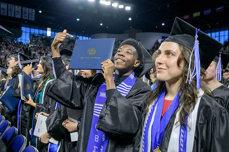 A proud Middle Tennessee State University graduate points to his degree during the spring 2025 commencement ceremony held Friday, May 9, inside Murphy Center on the MTSU campus in Murfreesboro, Tenn. (MTSU photo by J. Intintoli)