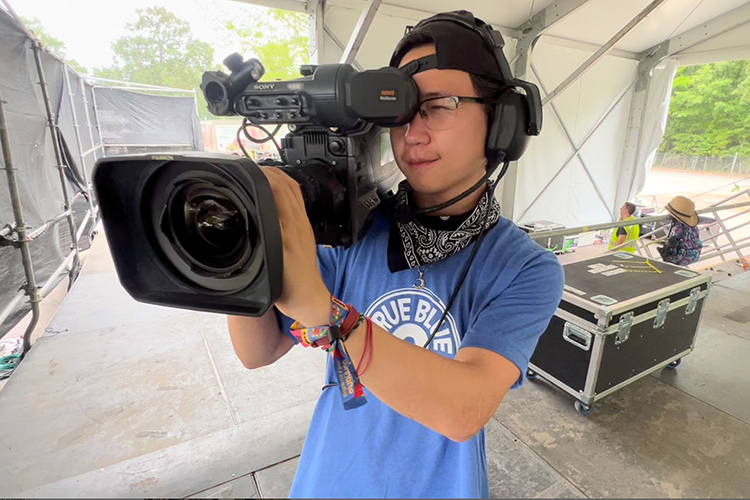 MTSU College of Media and Entertainment student Alex Dean prepares a camera to be used on Bonnaroo’s “This” stage as part of the university’s assignment to handle live TV production for streaming service Hulu of 25 concerts during the four-day festival. (MTSU Photo by Andrew Oppmann)