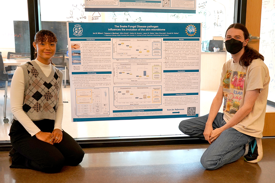 Middle Tennessee State University Honors students Tatyana Martinez, left, and Ian Wilson pose with the poster they presented at the 2025 Mycological Society of America conference earlier this year in Madison, Wisconsin. The poster session took place among undergraduate presentations. (MTSU photo by Robin E. Lee)