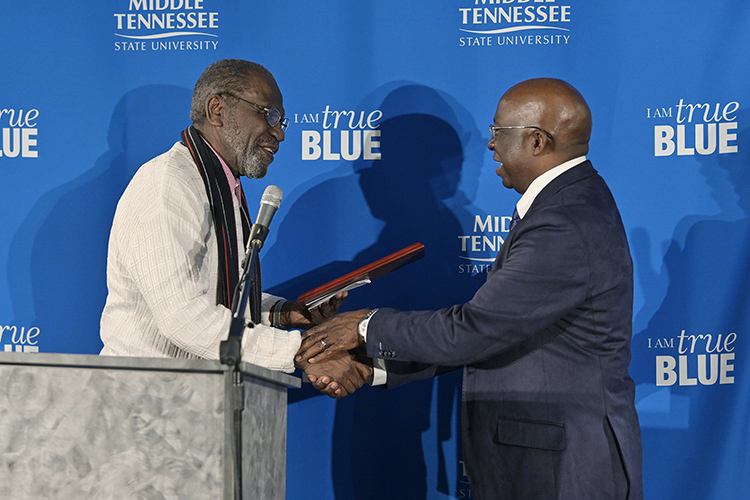 John Pleas, MTSU Emeritus Professor of Psychology, left, presents Frank Michello, MTSU finance professor, with the 2019 John Pleas Faculty Recognition Award at a ceremony held Thursday, Feb. 21, in the Ingram Center at MTSU. The award is presented to an outstanding minority faculty member. (MTSU photo by Andy Heidt)