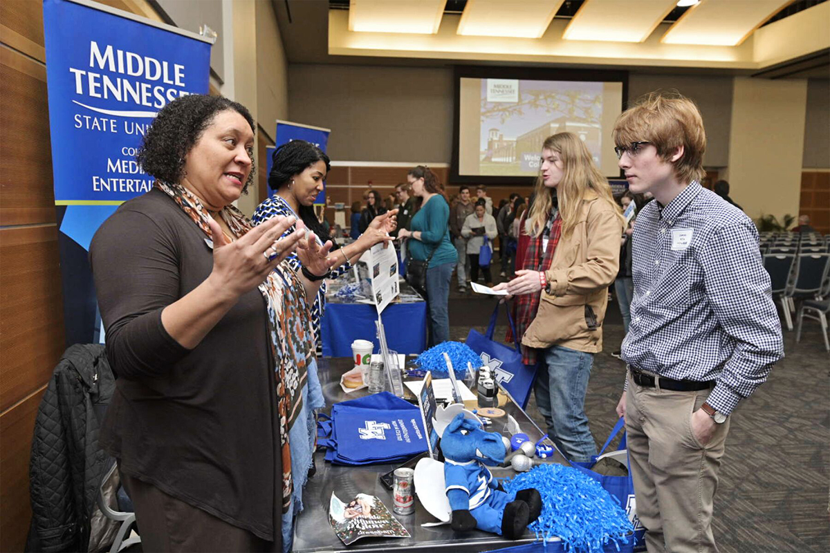 MTSU College of Media and Entertainment adviser Tiffany Milfort, left, shares information about her college with Lawson Hillis Feb. 18 during the annual Presidents Day Open House in the Student Union Ballroom. (MTSU photo by Andy Heidt)