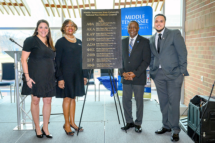 MTSU personnel and alumni attended a Feb. 17 dedication of 10 bronze plaques located in the Student Union Commons recognizing National Pan-Hellenic Council fraternities and sororities and the council’s 50-year relationship with the university. Standing with a prototype of the omnibus plaque are, from left, Leslie Merritt, director of Fraternity and Sorority Life; the Rev. Deborah Smith Owens, Eta Psi Chapter of Alpha Kappa Alpha Sorority Inc.; MTSU President Sidney A. McPhee; and Jalen Everett, president of the MTSU National Pan-Hellenic Council and member of Phi Beta Sigma. (MTSU photo by J. Intintoli)