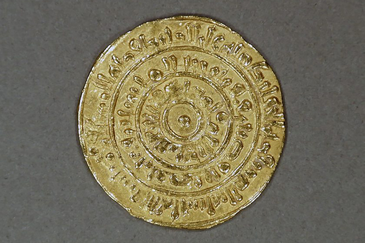 This gold coin, estimated to date to the 9th century, was struck at a mint in Misr, Egypt, during the Almoravid Dynasty. The writing on it reads, in part, "There is no God but God. Mohammed is the prophet of God." The coin is part of the "Caravans of Gold, Fragments of Time" exhibit at the Smithsonian Institution's National Museum of African Art in Washington, D.C. (Photo submitted)