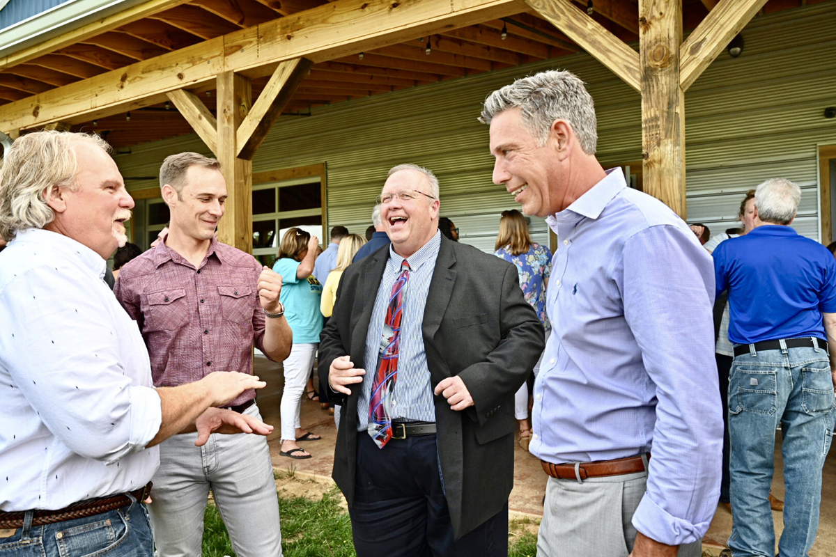 MTSU College of Basic and Applied Sciences Dean Bud Fischer, second from right, laughs at a comment made by Hop Springs and Steel Barrel Brewery founder and co-owner Mark Jones, left. Also taking part in the conversation are Jones’ business partners, Derrick Morse, second from left, and Lou Diaz. MTSU fermentation science and Hop Springs celebrated with a grand opening Thursday, May 23. (MTSU photo by J. Intintoli)