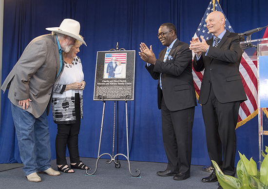 In this November 2015 file photo, Charlie and Hazel Daniels, left, view the metal plaque given by MTSU acknowledging their gifts and those from The Journey Home Project for the Charlie and Hazel Daniels Veterans and Military Family Center named in their honor. Celebrating the moment with them are MTSU President Sidney A. McPhee, second from right, and Keith M. Huber, senior adviser for veterans and leadership initiatives. (MTSU file photo by Andy Heidt)