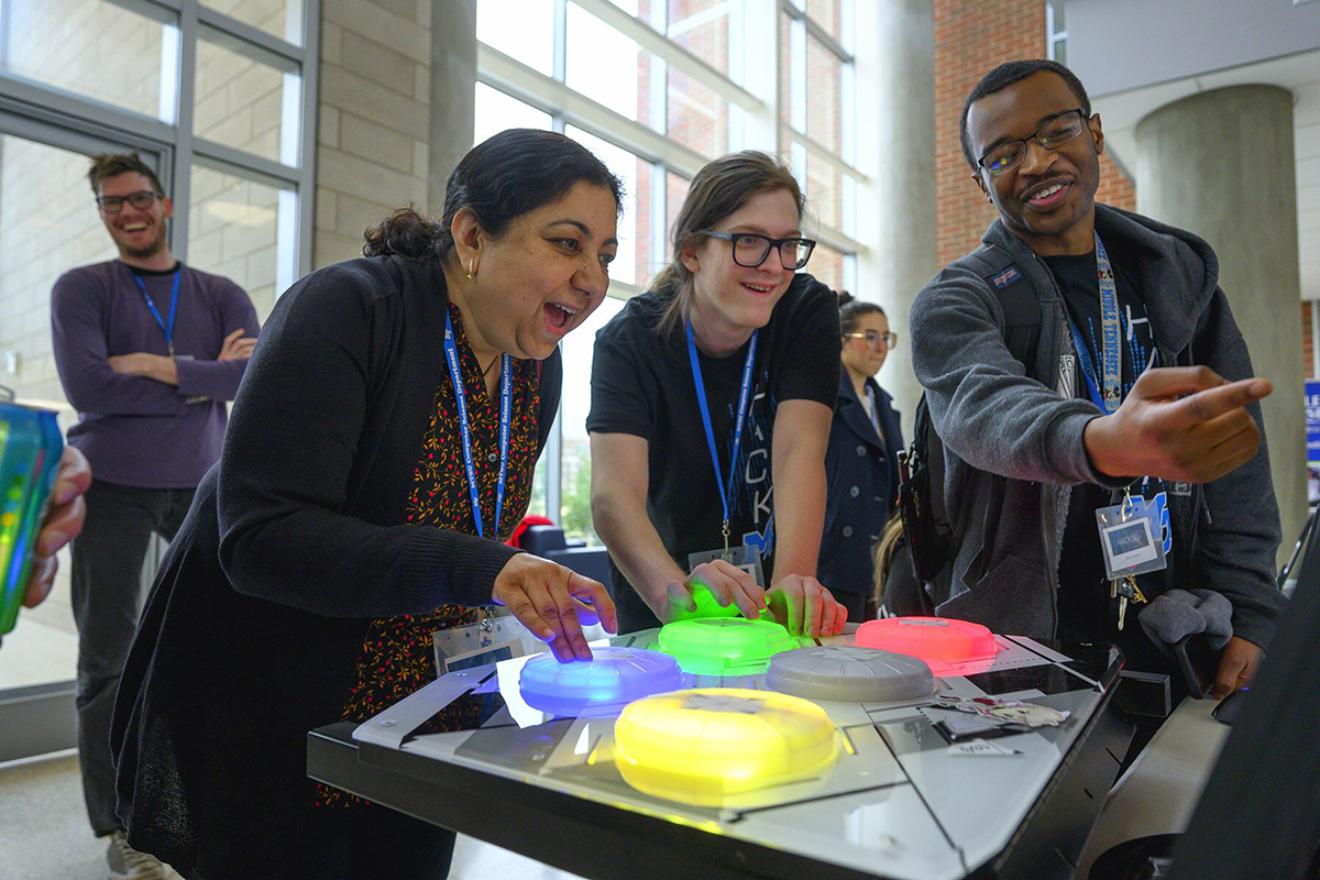 MTSU computer science Chair Medha Sarkar, left, and graduate student Steven Sheffey enjoy competing in one of the Infinity team’s games they created during the 36-hour HackMT in the Science Building’s first-floor atrium. MTSU sophomore team member Myles Chisholm, right, assists. More than a dozen teams and 150 students competed at the fifth annual event Sunday, Jan. 26.(MTSU photo by Cat Curtis Murphy)