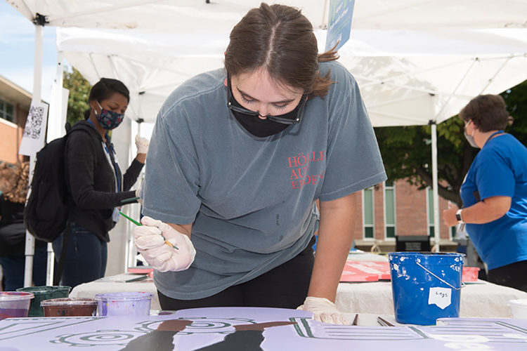 MTSU sophomore Jessica Schrader of East Ridge, Tenn., who's majoring in music business in the College of Media and Entertainment, plans her next painting move on an oversized wooden puzzle piece for "judgment and decision-making" during an outdoor "Pop-Up Mural Event" in September on campus. The 10 different handcrafted puzzle pieces, now ready for display, are part of a public art project collaboration between the College of Liberal Arts and the College of Basic and Applied Sciences to show students the interdisciplinary core skills they need for success. (MTSU photo by James Cessna)