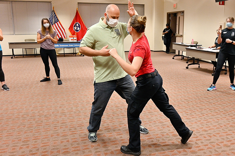 In this September 2021 file photo, Jason Hurley, Middle Tennessee State University Police training sergeant, models deflecting an attack with MTSU police officer Katelynn Erskine as part of the self-defense course Rape Aggression Defense Systems, or RAD, offered free of charge. Registration is open for the next RAD course that begins July 5, 2022. (MTSU file photo by Stephanie Barrette)