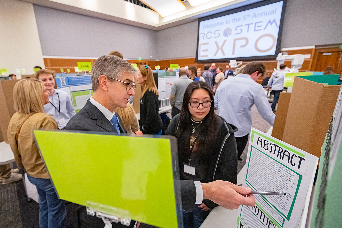 Greg Van Patten, left, dean of the Middle Tennessee State University College of Basic and Applied Sciences, discusses the abstract portion of Oakland High School senior Kelly Nguyen’s agricultural research project Monday, March 20, in the MTSU Student Union Ballroom. Nguyen plans to attend MTSU starting this fall, majoring in biochemistry on a premed pathway and awaiting word on being accepted into the Meharry Medical School Early Acceptance Program. (MTSU photo by Cat Curtis Murphy)