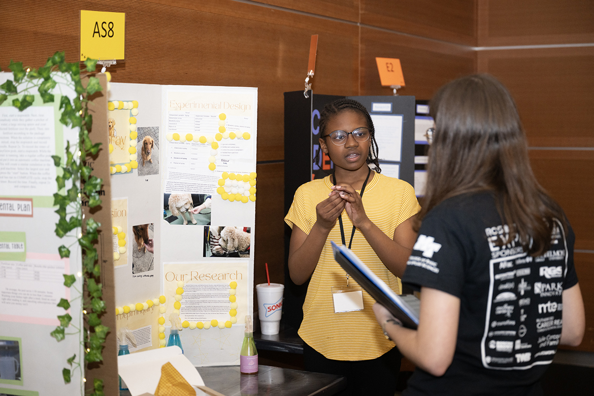 Kalleah Hall, a sixth grader at Thurman Francis Arts Academy in Smyrna, Tenn., explains her dog-related research to a judge at the recent RCS STEM Fair, held in the Student Union Ballroom at Middle Tennessee State University in Murfreesboro, Tenn. Some 400 students from 19 schools showcased 200 projects in the event where their study has focused on science, technology, engineering and math. (MTSU photo by James Cessna)