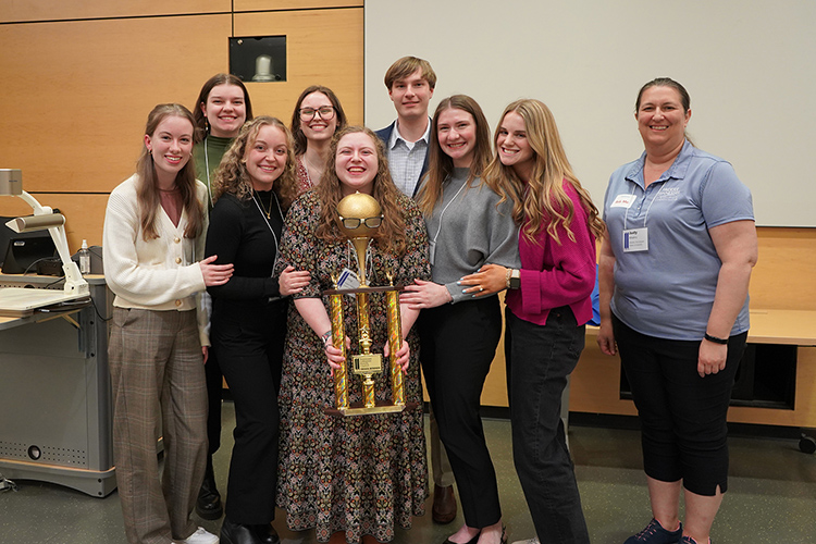 Trivia Bowl winners from Freed-Hardeman University stand with the trivia bowl trophy at the 2025 Tennessee Collegiate Honors Council two-day annual conference hosted Feb. 28-March 1 on the Middle Tennessee State University campus in Murfreesboro, Tenn. FHU students also won last year and will take home to Henderson, Tenn., for the second year in a row. (MTSU photo by Robin E. Lee)
