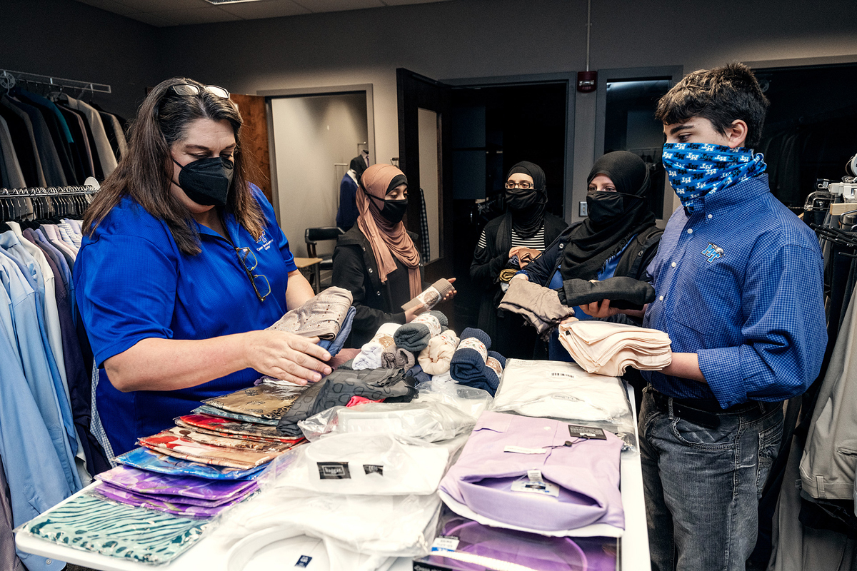 Kim Collins, left, executive aide in the MTSU Career Development Center, left, collects Muslim-friendly clothing items solicited by the Alnassari family — daughters, Zaynab and Fatima, mom Khadijah and son Ahmed. The triplets, 14, are dual enrollment freshmen, and biology majors pursuing a premed pathway. (MTSU photo by Andy Heidt) Khadijah Alnassari (Freshman) and her 14 year old triplets Ahmed, Fatima, and Zaynab, who are dual enrolled at MTSU in Career Closet and Science Building Biology Lab.