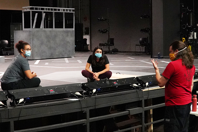 MTSU seniors Katlyn Marion of Murfreesboro, left, who portrays Juliet, and Alexa Pulley of Cunningham, Tenn., who portrays Romeo, listen intently as Department of Theatre and Dance lecturer David Wilkerson offers some suggestions during a rehearsal for the university's Oct. 1-4 production of William Shakespeare's "Romeo and Juliet." Wilkerson is directing the show, which will air live at MTSU.edu/live, the True Blue TV channel and the MTSU and MTSU Theatre Facebook Live sites. A few free in-person tickets are also available for students. (MTSU Department of Theatre and Dance photo)