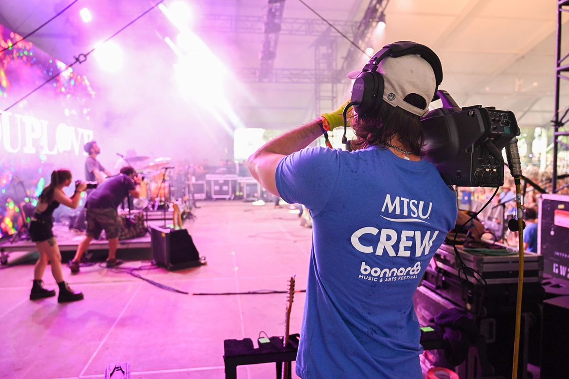 A Middle Tennessee State University College of Media and Entertainment student films a performance at the 2024 Bonnaroo Music and Arts Festival in Manchester, Tenn. MTSU students worked the This and That tent stages, airing dozens of performances worldwide on Hulu’s streaming platform. (MTSU photo by James Cessna)