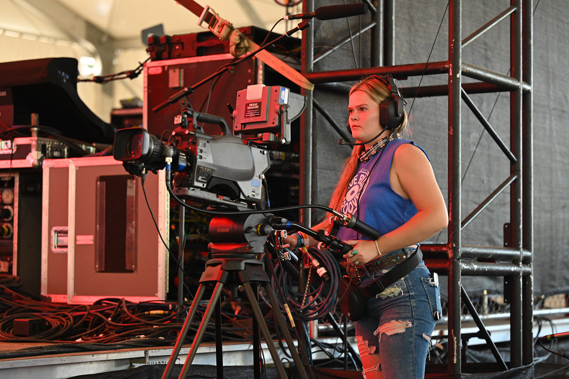 A Middle Tennessee State University College of Media and Entertainment student films a performance at the 2024 Bonnaroo Music and Arts Festival in Manchester, Tenn. MTSU students worked the This and That tent stages, airing dozens of performances worldwide on Hulu’s streaming platform. (MTSU photo by James Cessna)