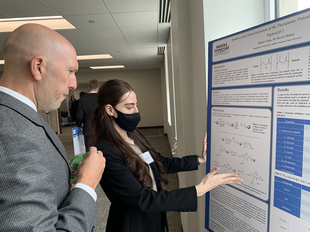 MTSU chemistry major Maria Clark, left, talks about her undergraduate research with Greg Rushton, director of the Tennessee STEM Education Center and a chemistry professor, Wednesday, Feb. 16, during the annual Posters at the Capitol. Clark was among seven MTSU students and nearly 40 altogether participating in the event in the Cordell Hull Building in Nashville. (MTSU photo Randy Weiler)