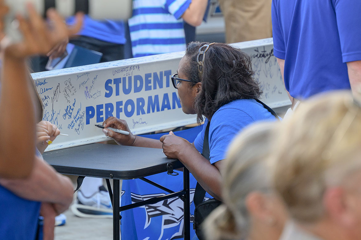 A fan signs a ceremonial beam for the new Stephen and Denise Smith Student-Athlete Performance Center on campus in Murfreesboro, Tenn., at the facility’s ribbon-cutting ceremony held Wednesday, July 30. (MTSU photo by J. Intintoli)
