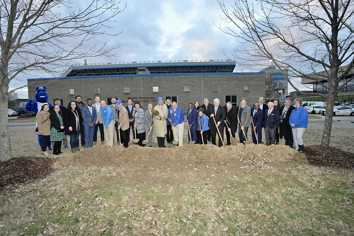 Middle Tennessee State University President Sidney A. McPhee, center right in blue suit, is joined by representatives of the MTSU Board of Trustees, Athletic Department, Campus Planning and the Blue Raider Athletic Association for the ceremonial shoveling of dirt during the Thursday, Jan. 26, groundbreaking for the new $66 million Student-Athlete Performance Center that will connect to the north end of Floyd Stadium. (MTSU photo by Andy Heidt)