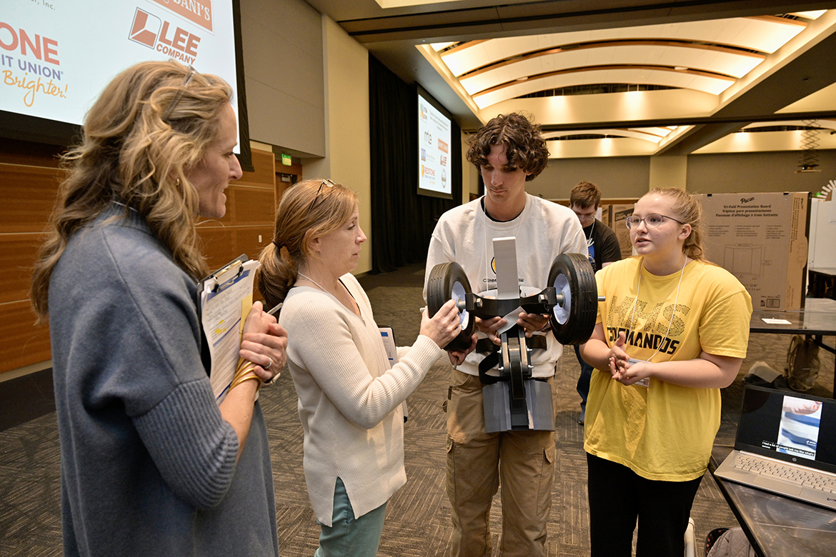 Event judges Lady Hamilton, left, and Maureen Bennett from Middle Tennessee State University Student Health Services check out a cart built for a dog named Panda 
— the completion of research called the “Panda Project” by Hendersonville High School seniors Matthew Jackson of Gallatin, Tenn., and Ella Holtermann of Hendersonville, Tenn. The judges’ inquiry occurred Wednesday, April 3, during the 12th annual Middle Tennessee STEM Innovation Hub STEM Expo in the Student Union Ballroom on the Middle Tennessee State University campus in Murfreesboro, Tenn. (MTSU photo by Andy Heidt)
