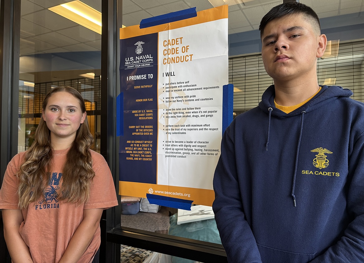 Nina Dotres, left, of Punta Gorda, Fla., and John Burkett of Bay Minette, Ala., stand at the U.S. Naval Sea Cadet Corps code of conduct sign near the Jim Cummings Hall lobby on the Middle Tennessee State University campus in Murfreesboro, Tenn., Friday, June 13. They were among nearly 90 Sea Cadets, ages 10 to 18, participating in a variety of activities June 6-19. (Submitted photo)