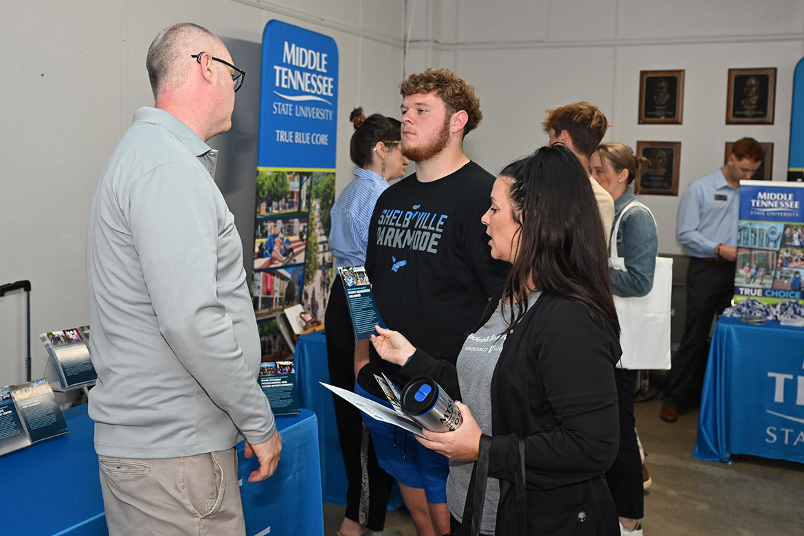 Shelbyville Central High School senior Colton Clardy, center, and his mother, Carrie Beth Boyce, right, talk with Middle Tennessee State University representative Kevin States at the 2025 True Blue Tour kickoff student reception held Tuesday night, Sept. 16, at the Blue Ribbon Circle Club in Shelbyville, Tenn. (MTSU photo by James Cessna)