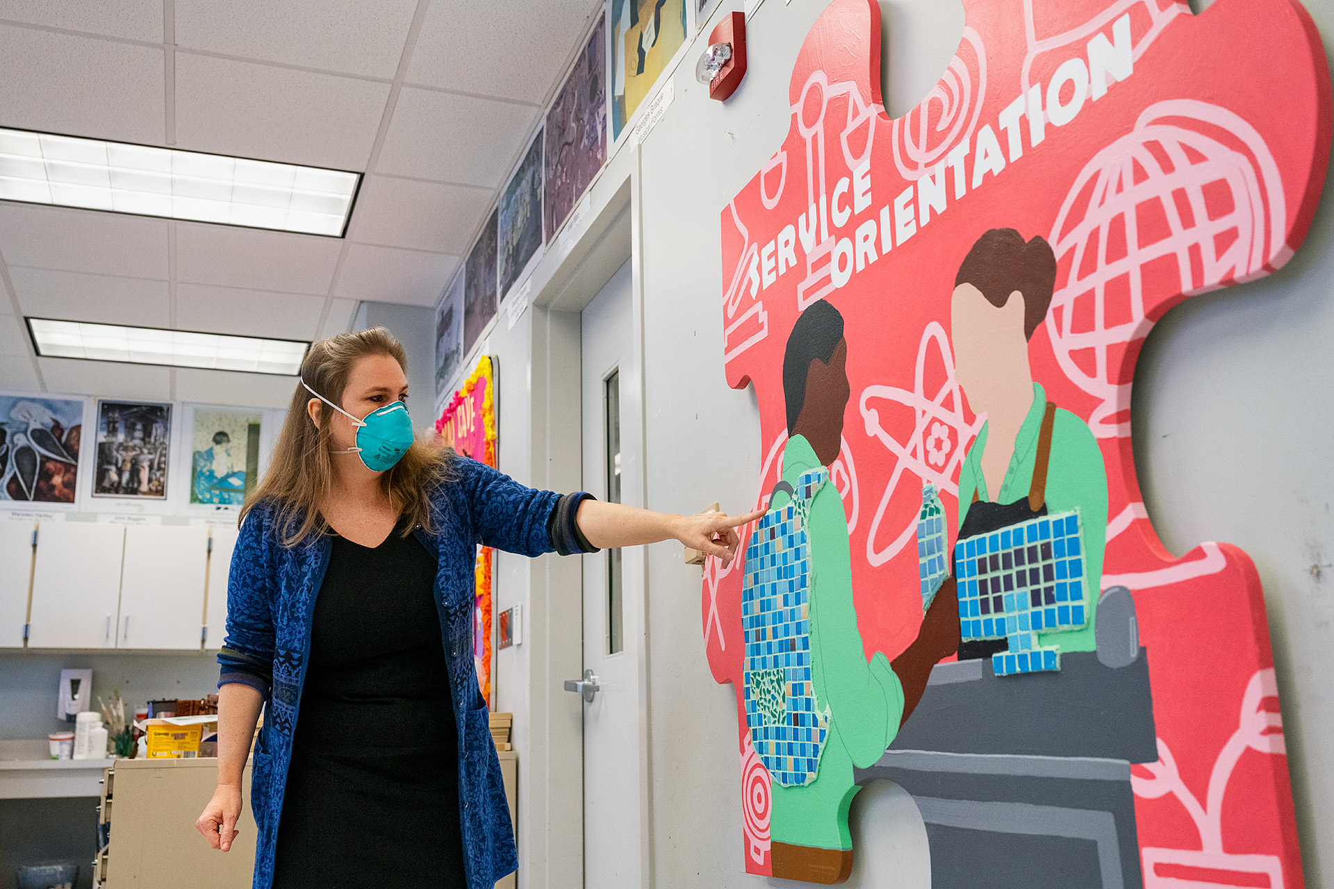 MTSU art education professor Debrah Sickler-Voigt checks the mosaic tiles added to an oversized wooden puzzle piece for "service orientation" in Todd Hall Thursday, Nov. 19. The 10 different handcrafted puzzle pieces, touched up, with mosaics added, and ready for display, are part of a public art project collaboration between the College of Liberal Arts and the College of Basic and Applied Sciences to show students the interdisciplinary core skills they need for success. (MTSU photo by Andy Heidt)