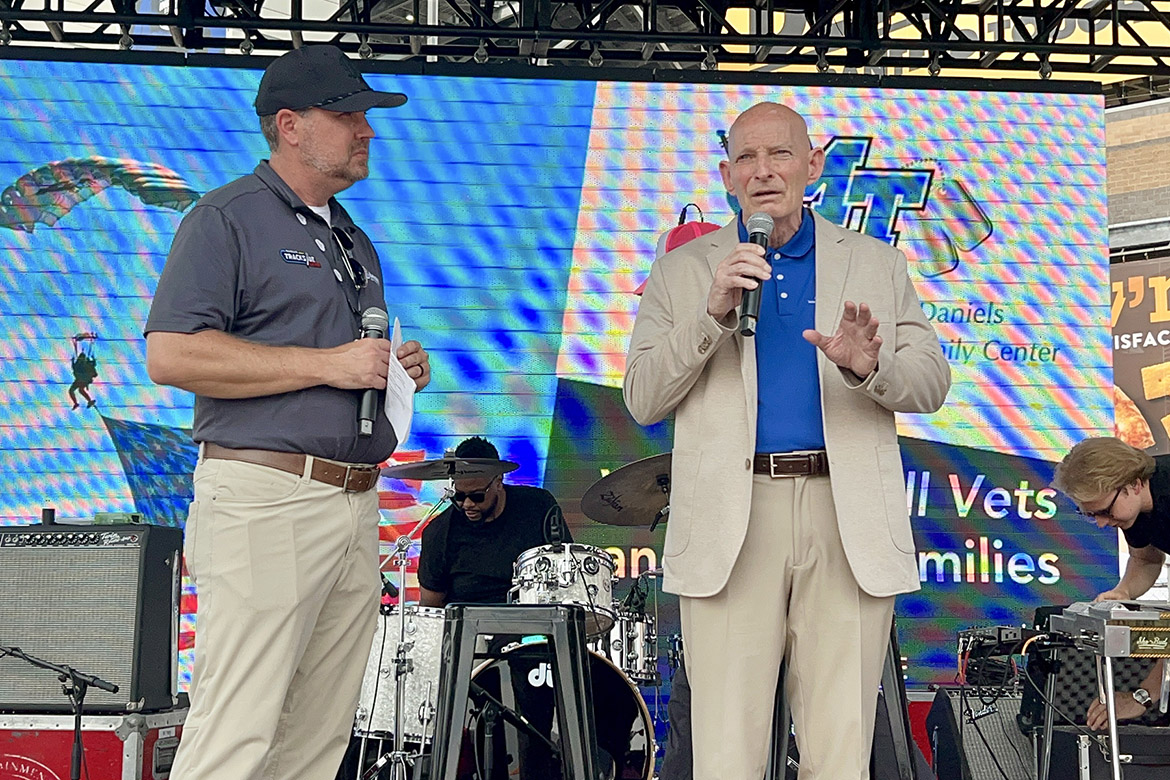 Retired Lt. Gen. Keith Huber, right, senior adviser for veterans and leadership initiatives at Middle Tennessee State University in Murfreesboro, Tenn., speaks to NASCAR fans in the Nashville Superspeedway Fan Fun Zone about the services provided by the university’s Charlie and Hazel Daniels Veterans and Military Family Center the June 1 Cracker Barrel 400 at the superspeedway in Lebanon, Tenn. (MTSU photo by Andrew Oppmann)