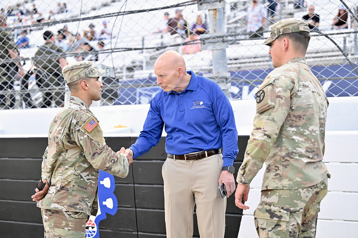 Retired Lt. Gen. Keith Huber, senior adviser for veterans and leadership initiatives at Middle Tennessee State University in Murfreesboro, Tenn., greets two active-duty service members during his appearance as the honorary track official at the May 30 Rackley Roofing 200 at Nashville Superspeedway in Lebanon, Tenn. (MTSU photo by James Cessna)