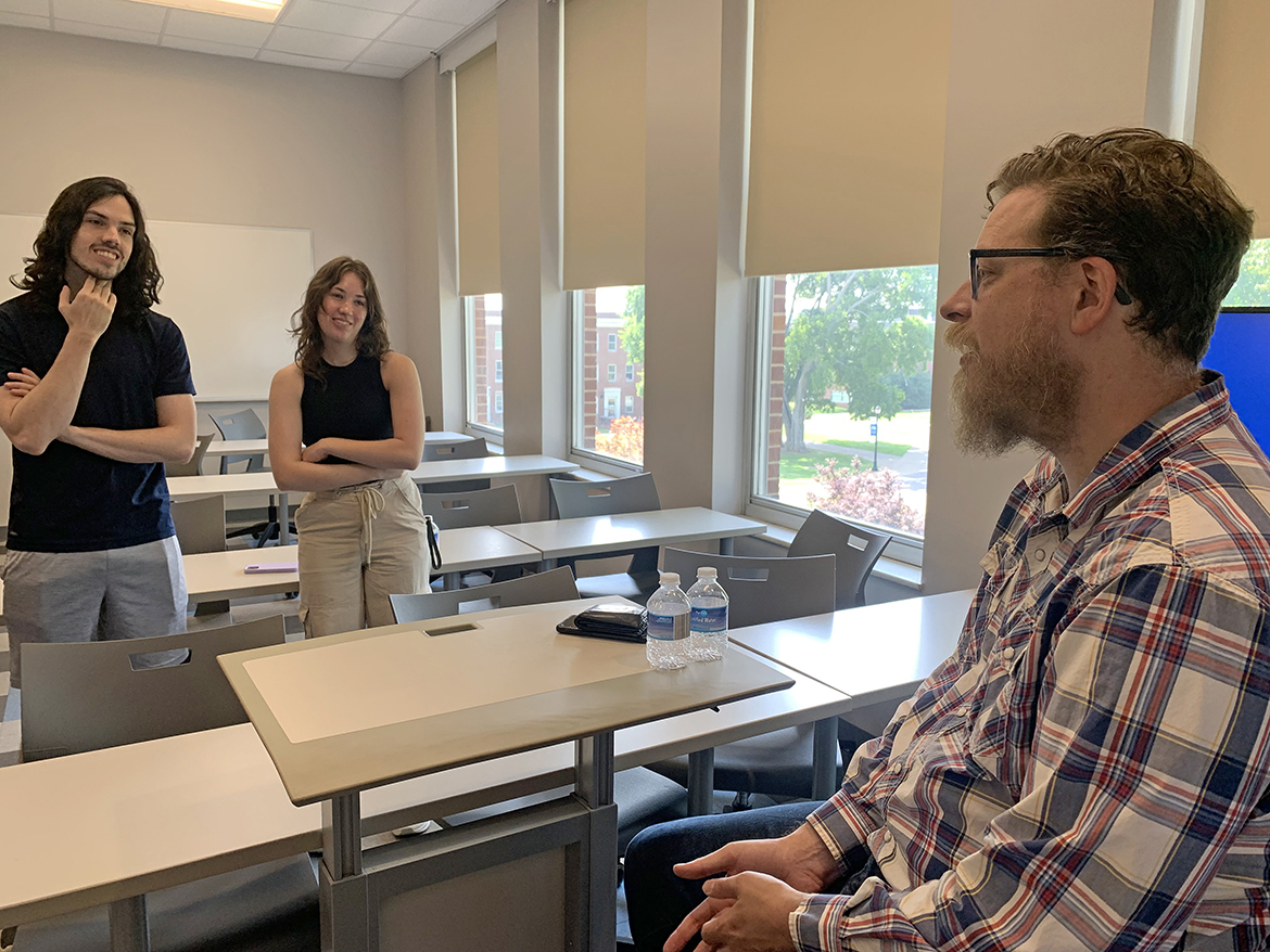 Brother and sister Nick, left, and Abby Stephens of Murfreesboro, Tenn., gain insight into sports data analytics from Micah McCurdy, who created and owns www.hockeyviz.com. In Nashville, Tenn., for the 2023 NHL draft, McCurdy was invited to the MTSU campus by Chris Stephens, the Department of Mathematical Sciences chair and father of the two MTSU students. Nick Stephens, 20, is a junior majoring in data science. Abby Stephens, 19, is a construction management major in the School of Concrete and Construction Management. (MTSU photo by Randy Weiler)