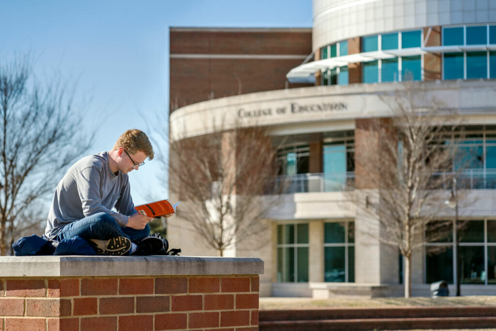MTSU student, Joseph Jones, studying in front of the College of Education building. (MTSU file photo by J. Intintoli)
